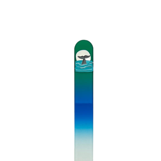 Glass nail file in green and blue with hand painted whale tail in water with white sun in background and 