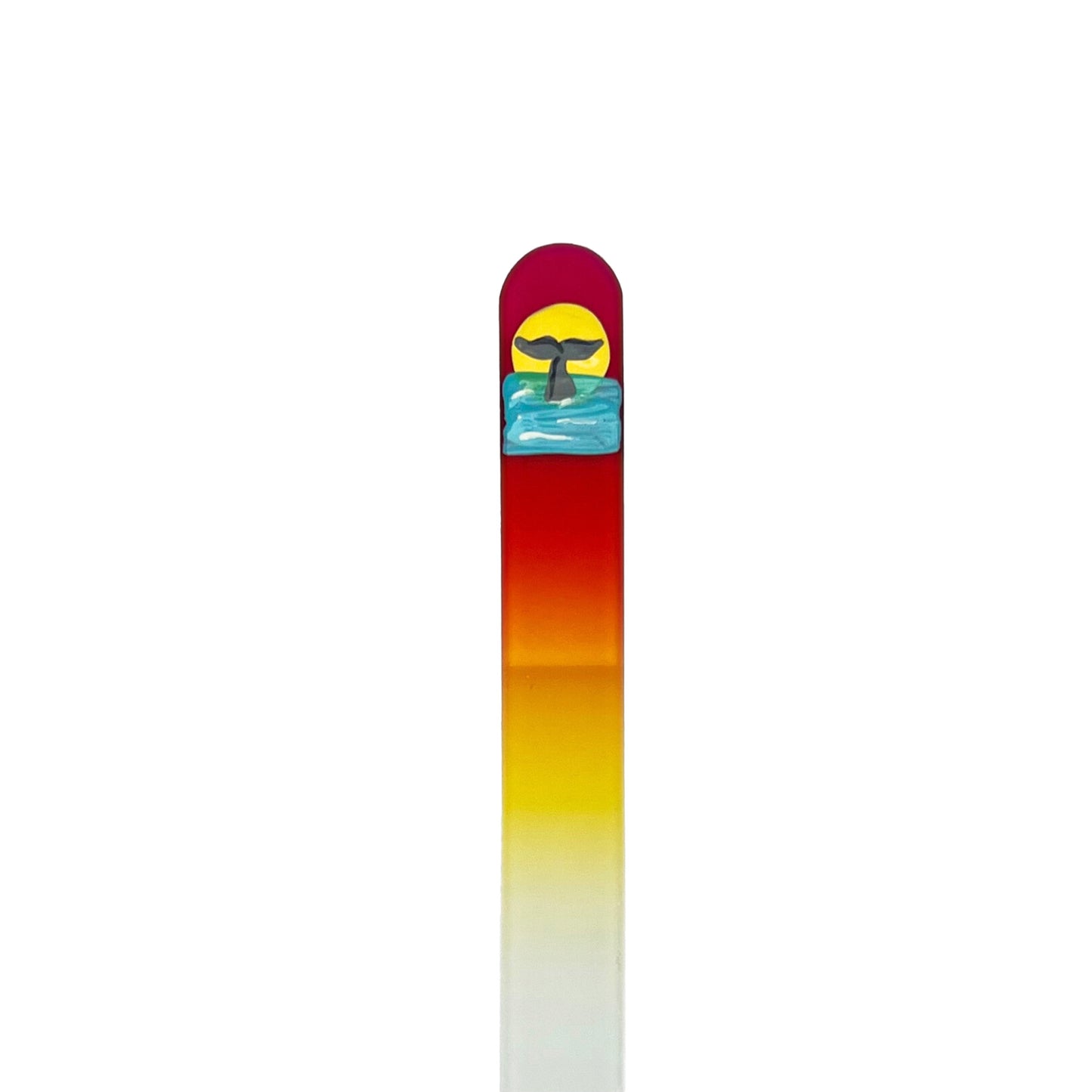 Pink and yellow glass nail file with hand painted whale tail in water with sun in background.